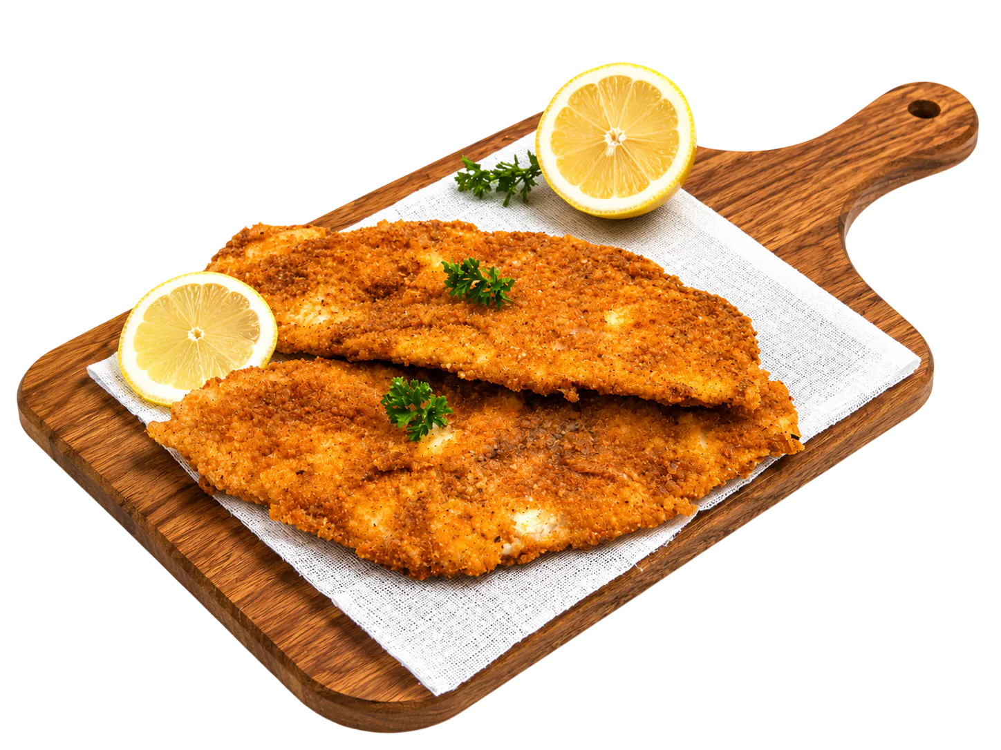 Two breaded fried fish fillets garnished with parsley and lemon halves on a wooden cutting board.